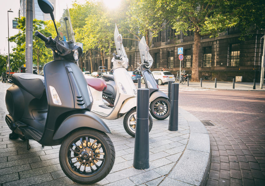 3 motos aparcadas en la acera de una ciudad